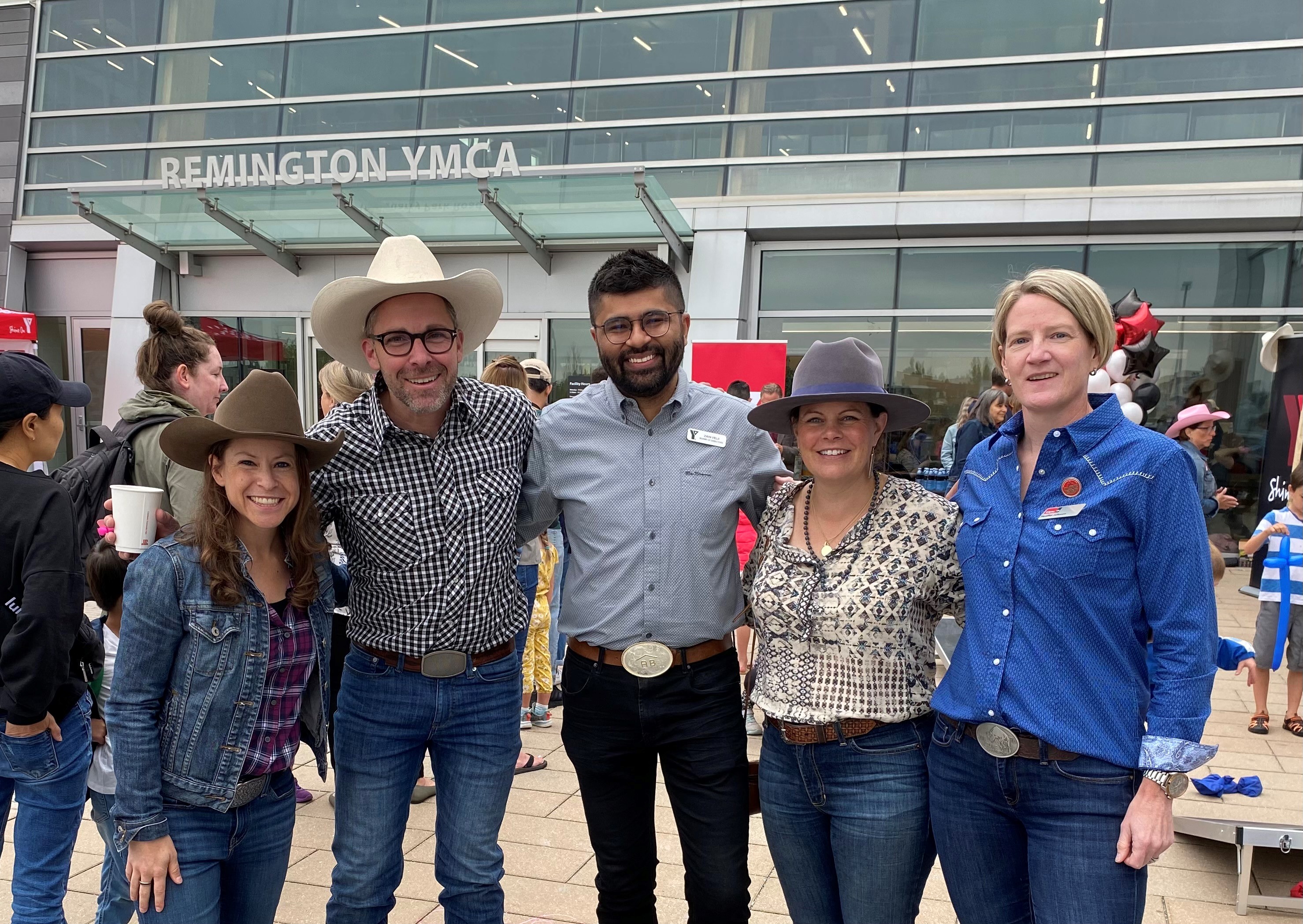 Zain Velji, YMCA Calgary board member and past-chair, poses with YMCA Calgary staff at the 2023 Stampede Breakfast at Remington YMCA.