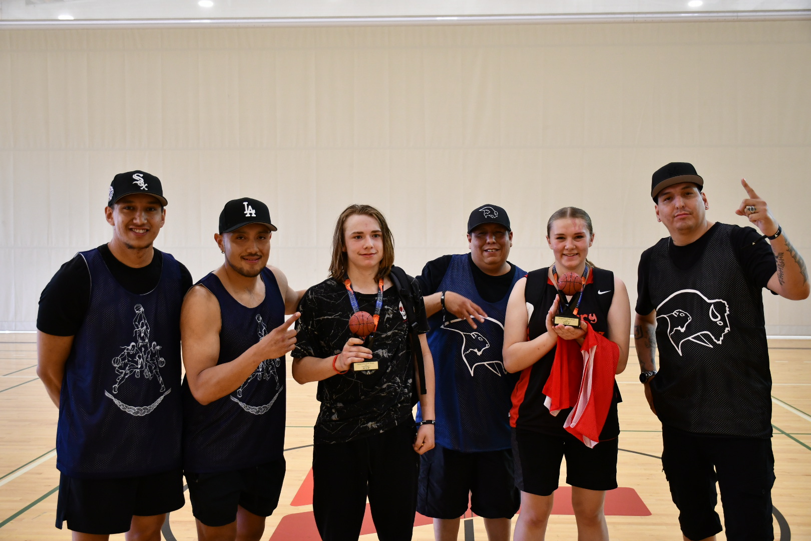 A group of youth pose for a photo as MVPs from the basketball tournament