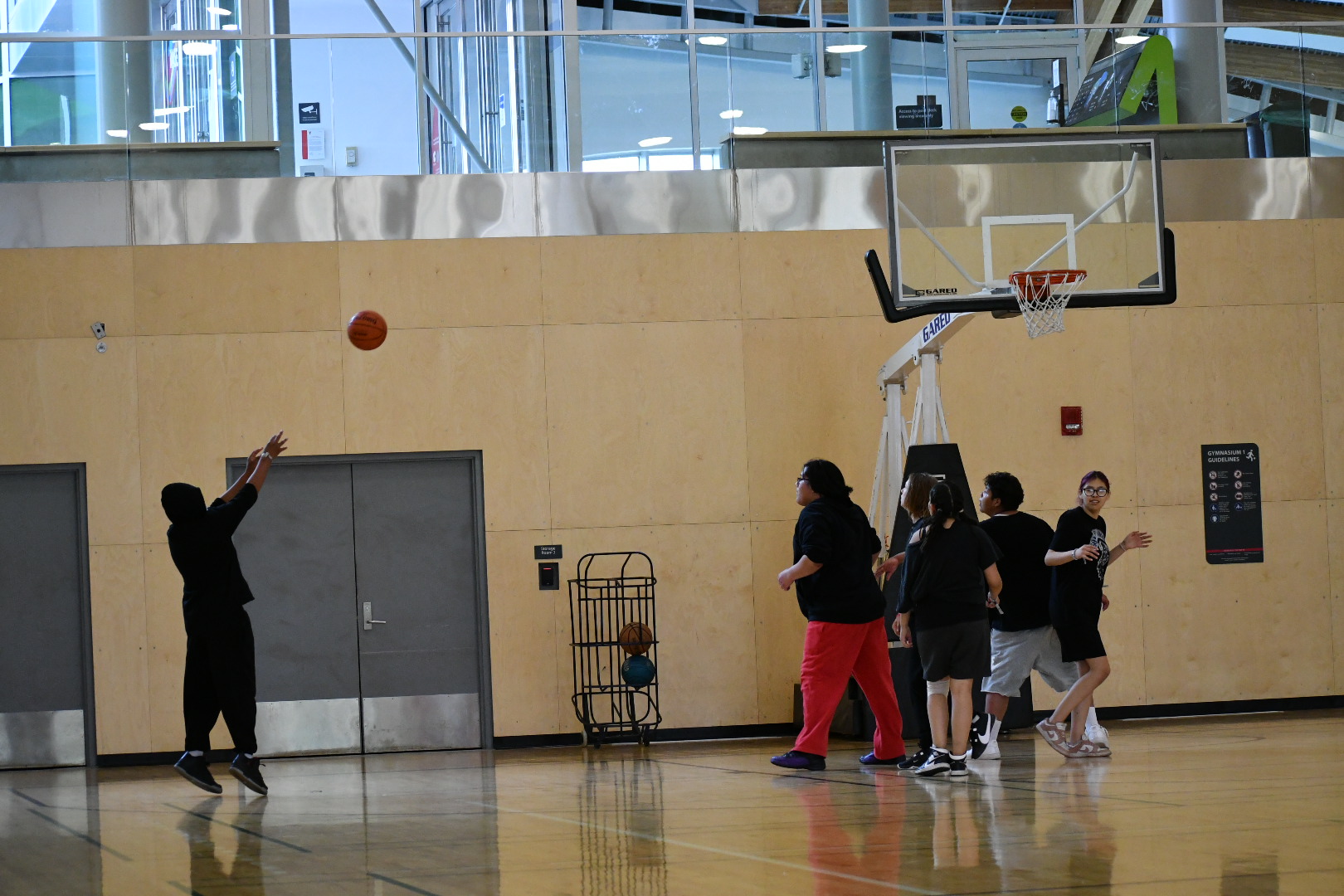 A basketball player shoots at the hoop during the tournament