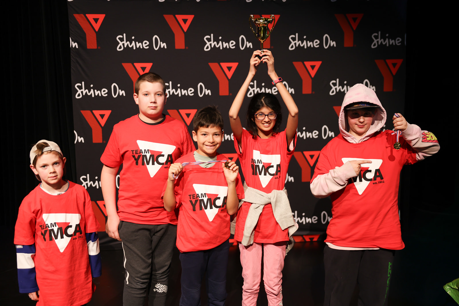 A group of youth pose in YMCA t-shirts as part of the YMCA esports tournament