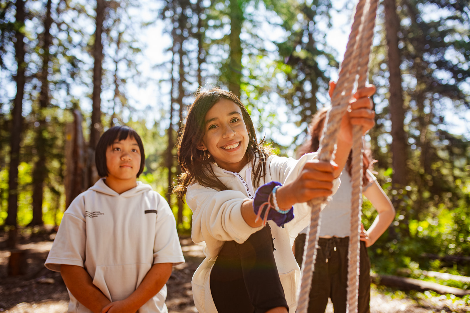 A youth participates in a rope challenge course at Camp Chief Hector YMCA