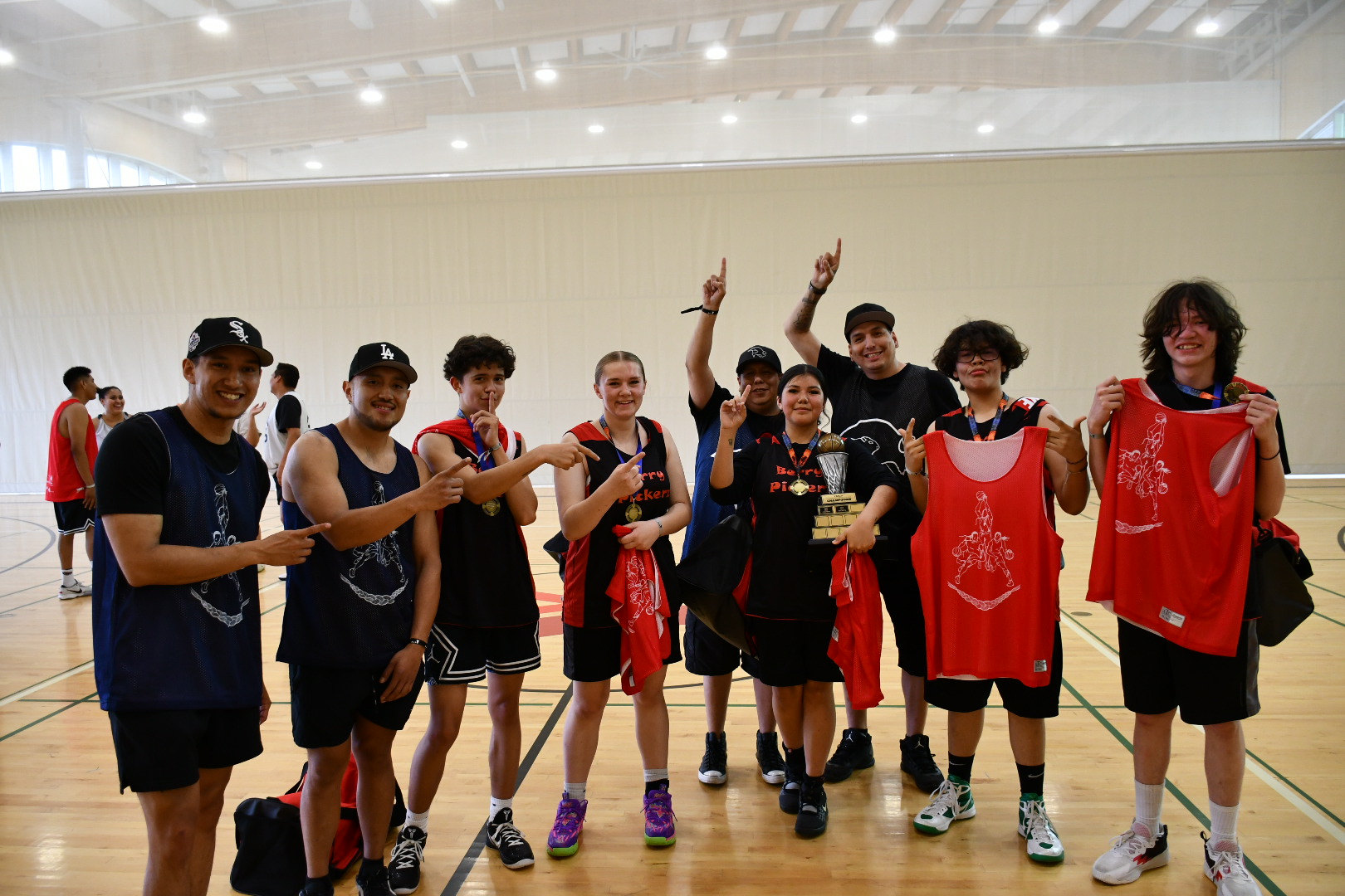 A group of youth pose after a basketball tournament
