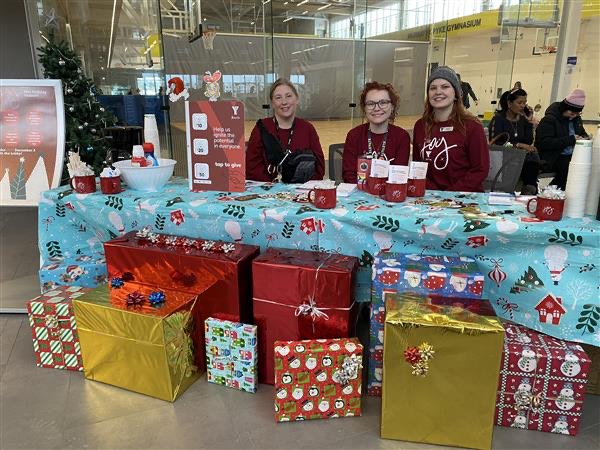 A group of people in a holiday-themed setting on JOY day at the YMCA