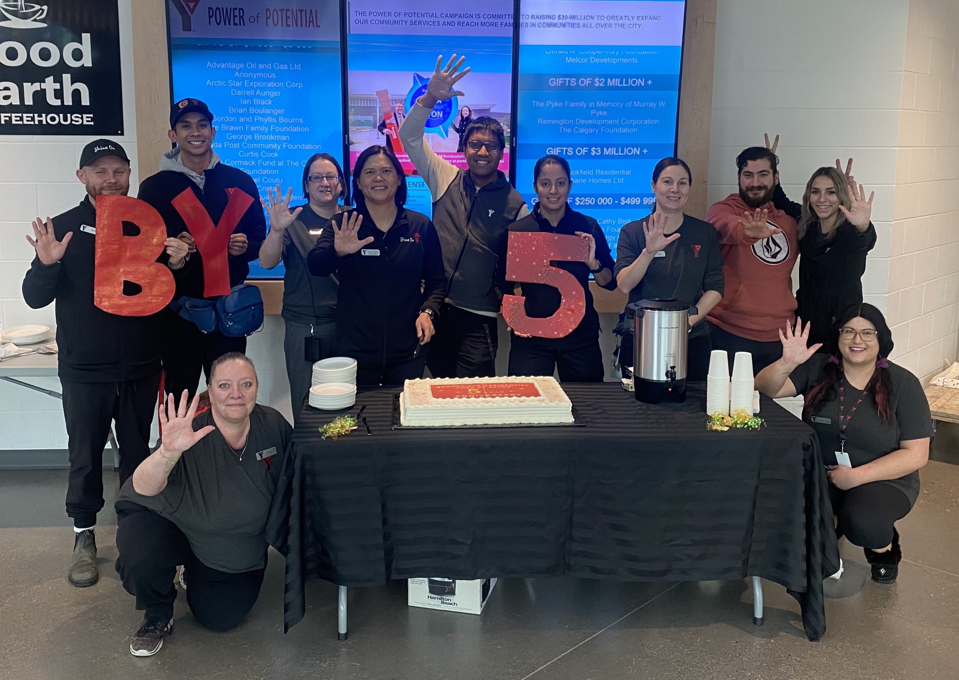 A group of staff at Brookfield Residential YMCA celebrate 5 years