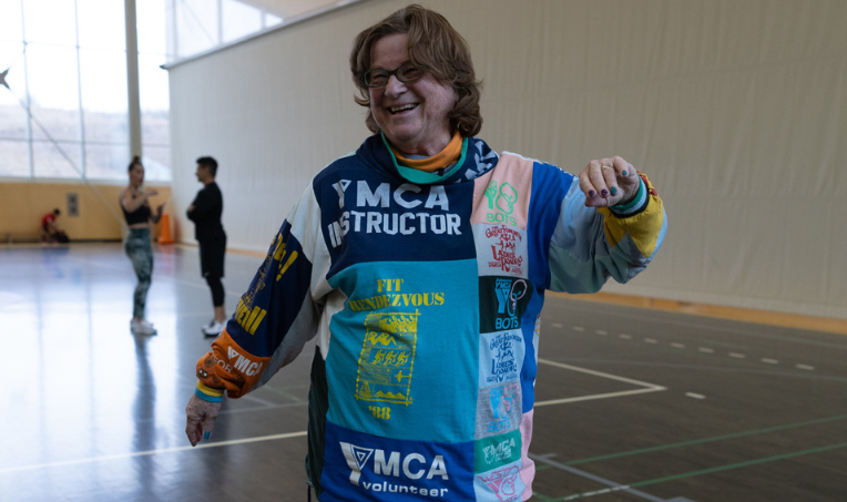 A photo of a female YMCA volunteer wearing glasses