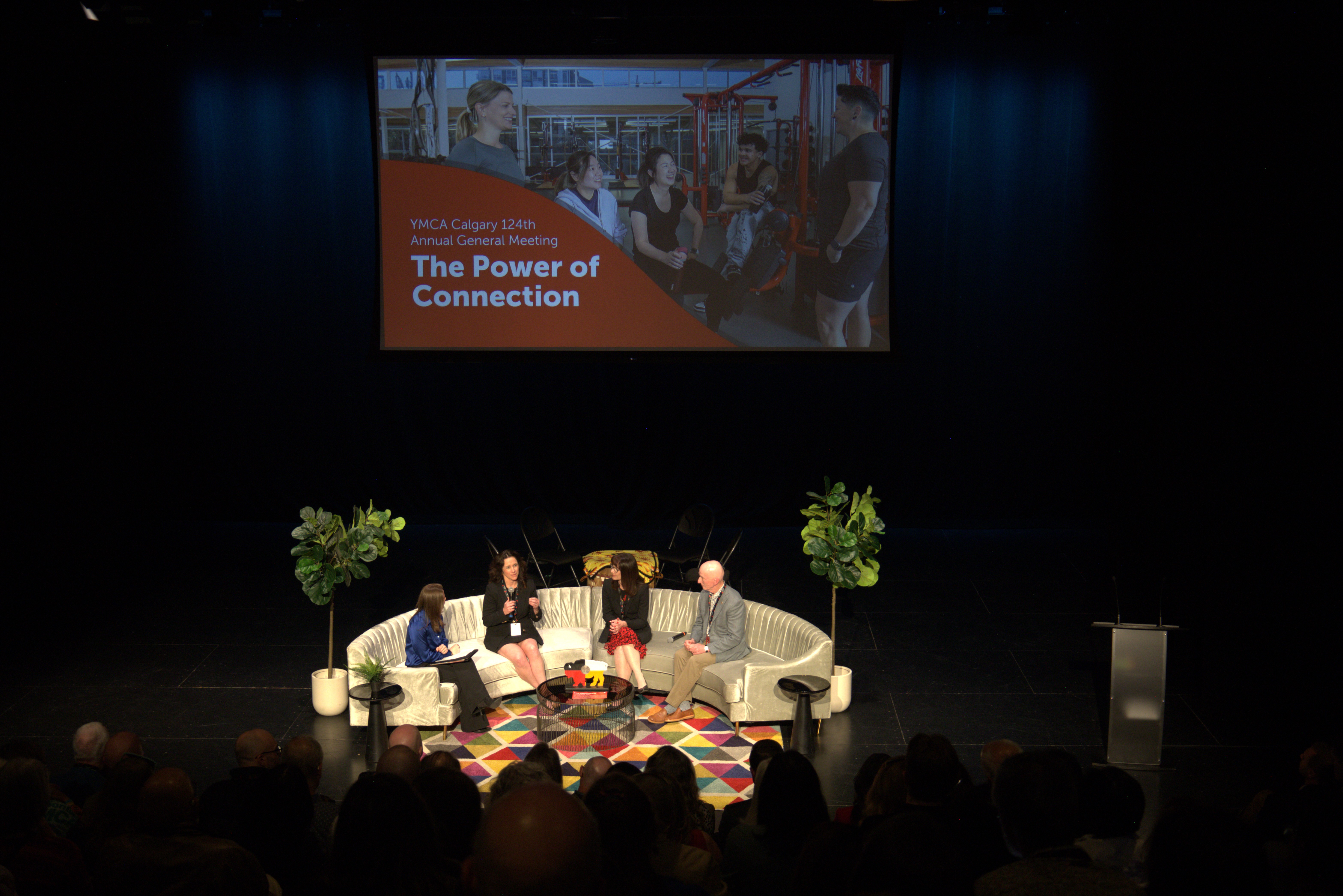 Four panelists sitting on a couch talking