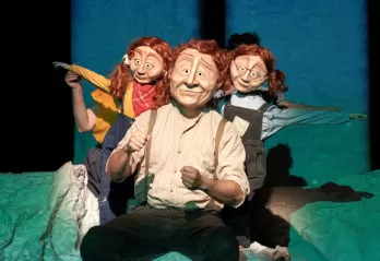 Family consisting of a dad and twin daughters wearing masks