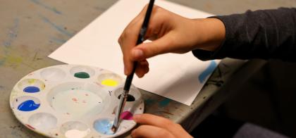 hands holding paint brush