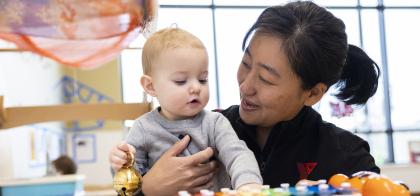 young child hugging educator