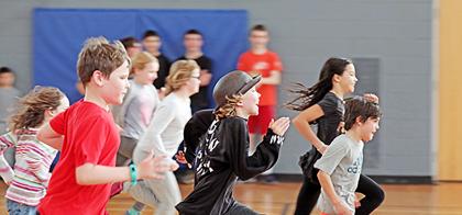large group of youth running in gym