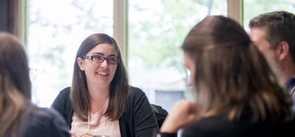 professional woman smiles in meeting