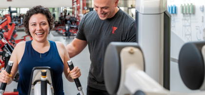 Personalized progression YFit Certified trainer and client on the weight floor