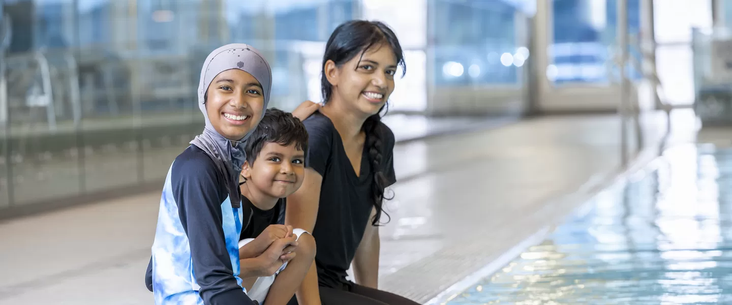 single mom family sitting by the pool