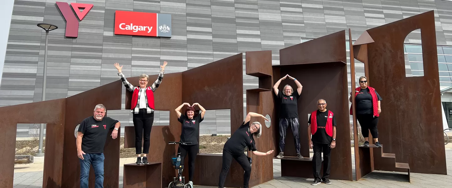 Volunteers outside of branch doing YMCA with arms