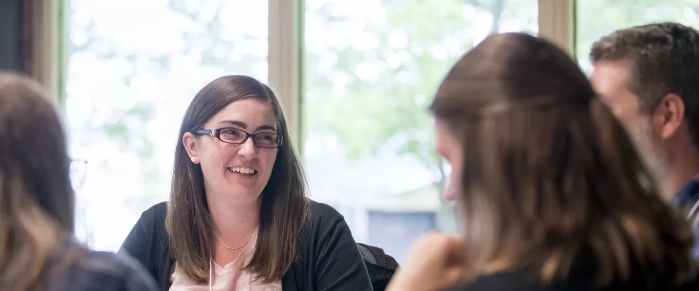professional woman smiles in meeting
