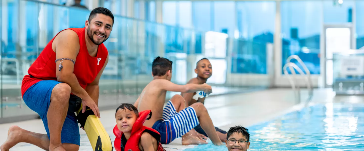 YMCA Lifeguard and kids swimming