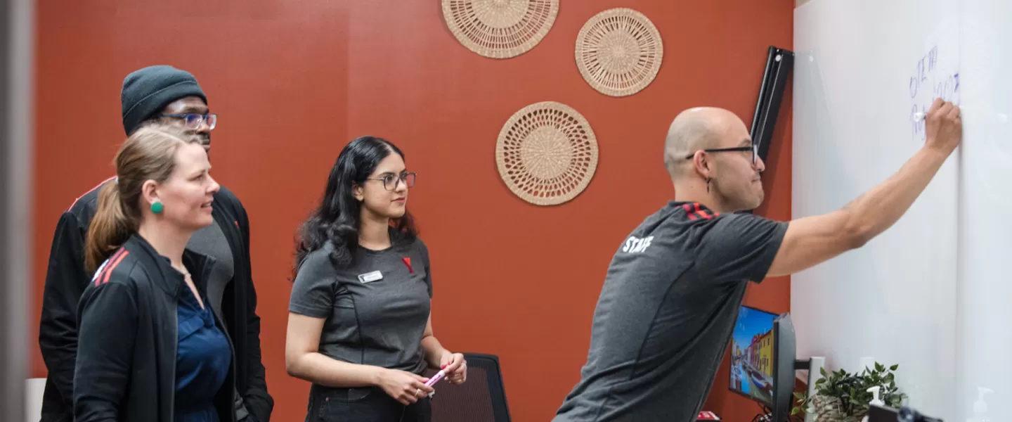 YMCA staff writing on a white board