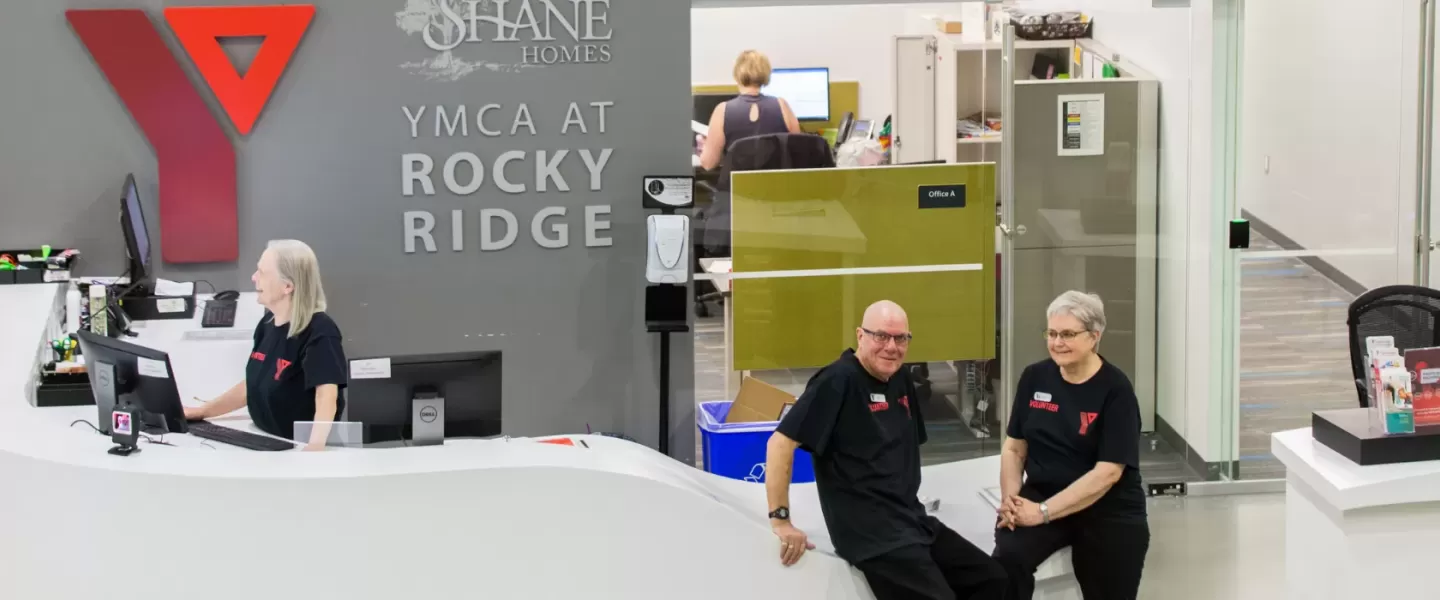 YMCA volunteers standing at the front desk