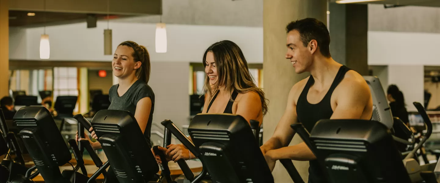 Young adults in the gym on the fitness machine