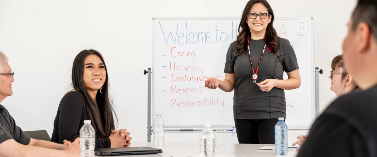 YMCA staff in the meeting room with white board