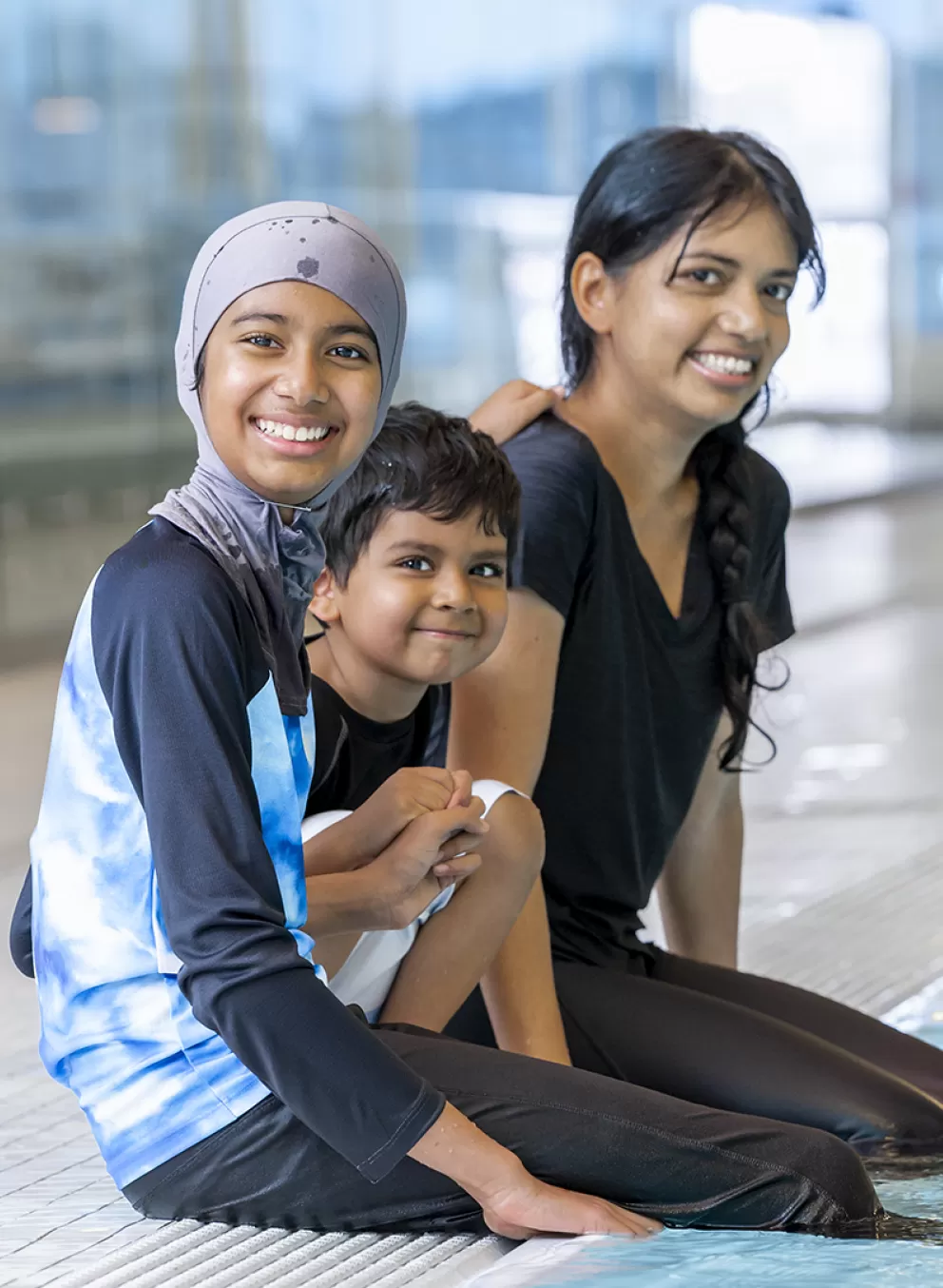 single mom family sitting by the pool