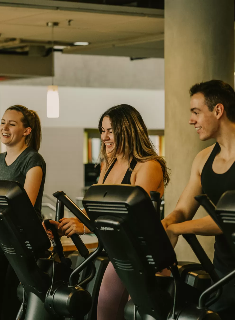 Young adults in the gym on the fitness machine
