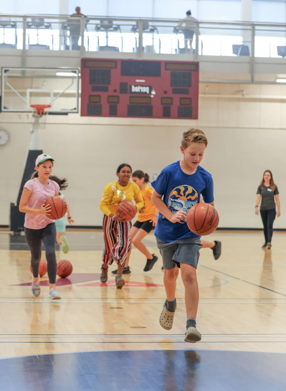 Kids in the gynesium playing basketball 2
