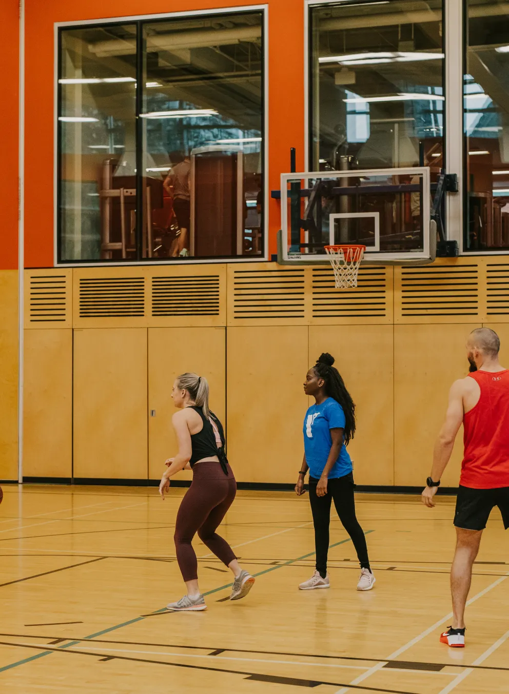 Staff and adults playing basketball