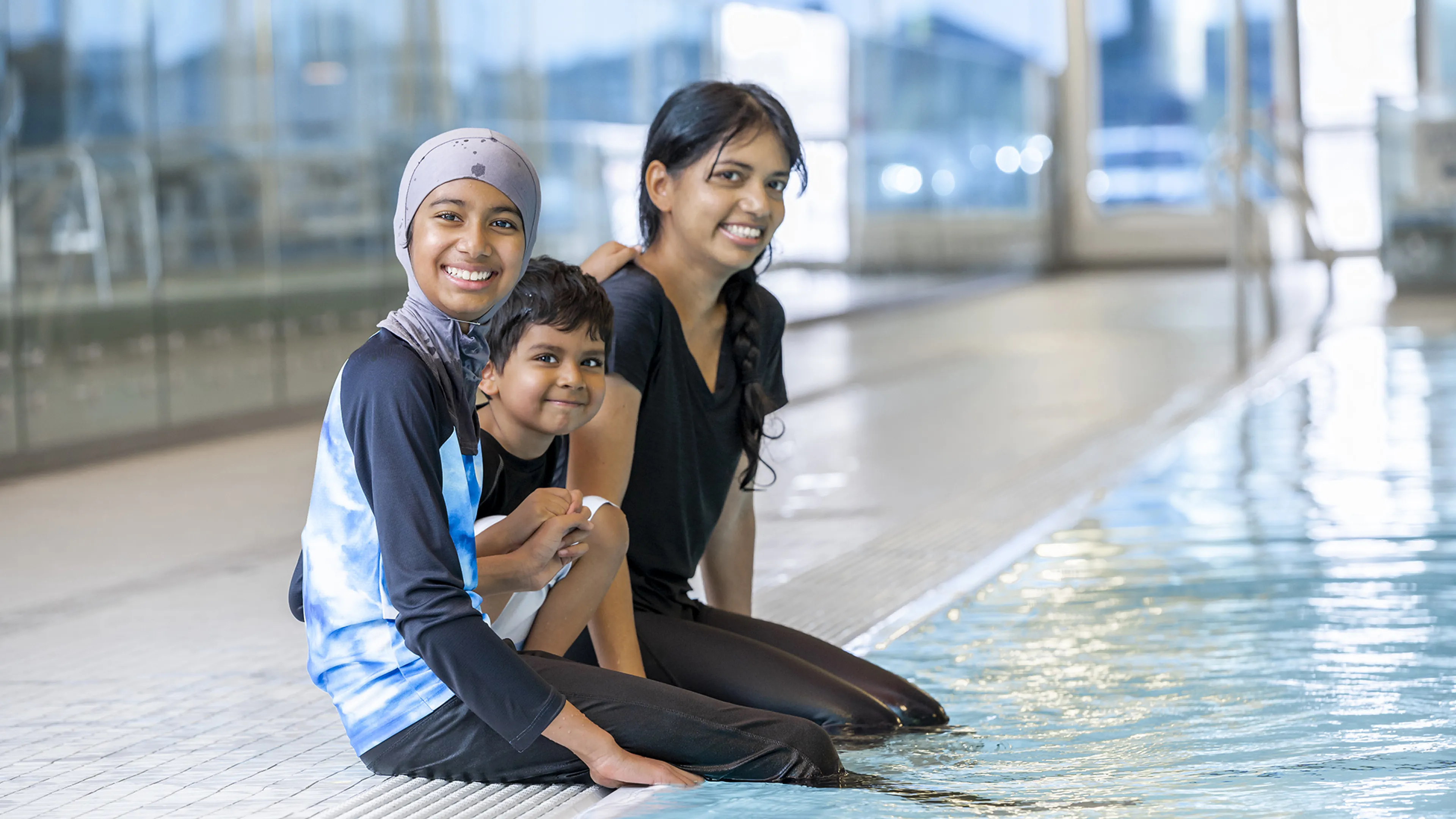 single mom family sitting by the pool