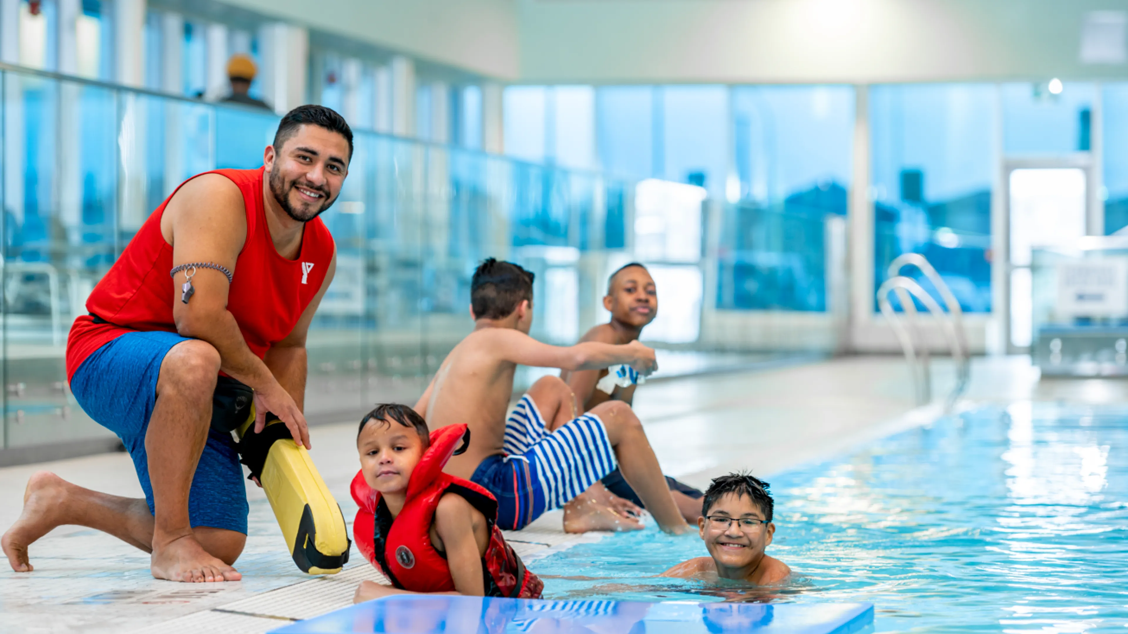 YMCA Lifeguard and kids swimming