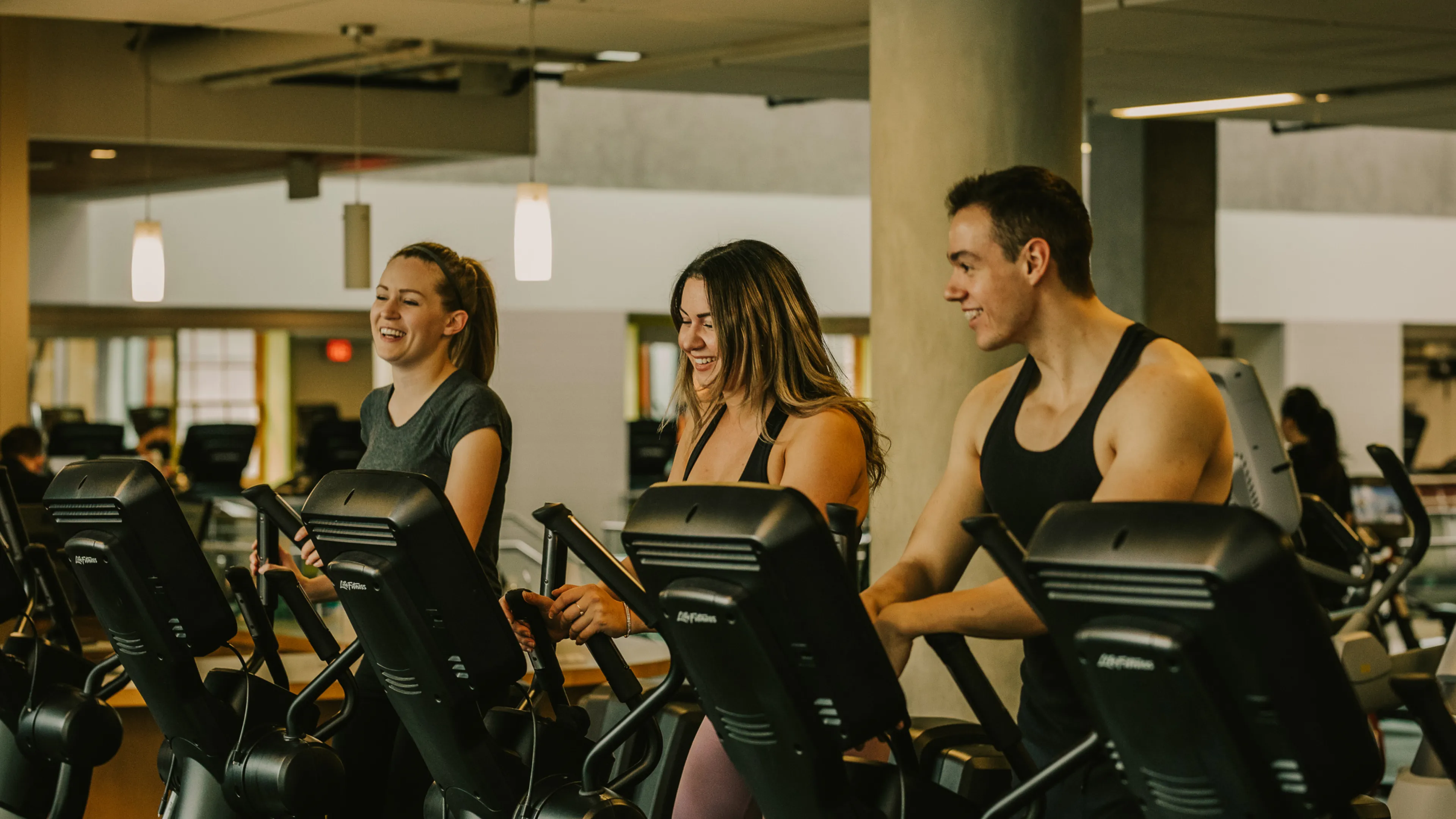 Young adults in the gym on the fitness machine