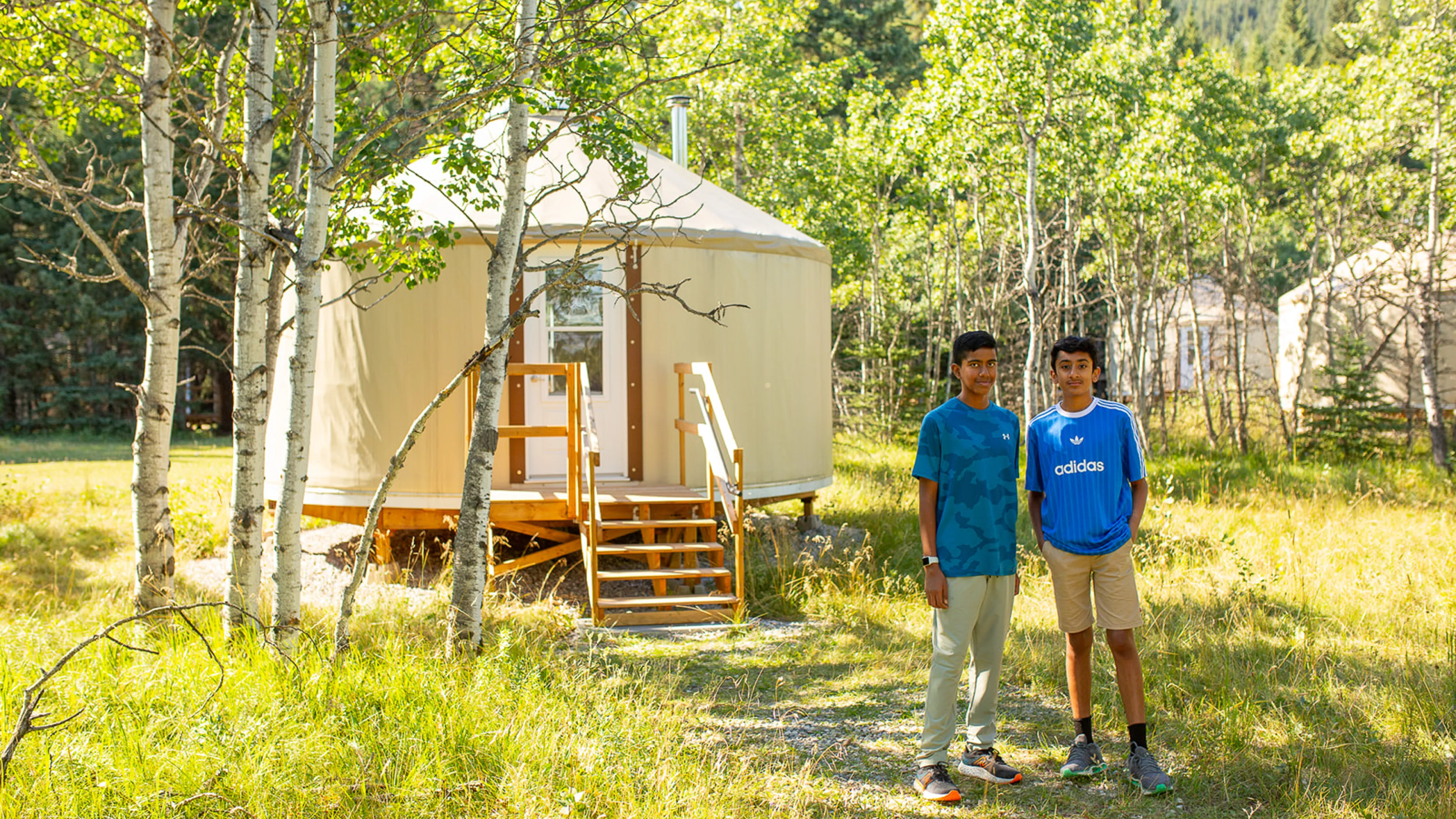 Two boys standing in fron of Yurt at Camp Chief Hector YMCA