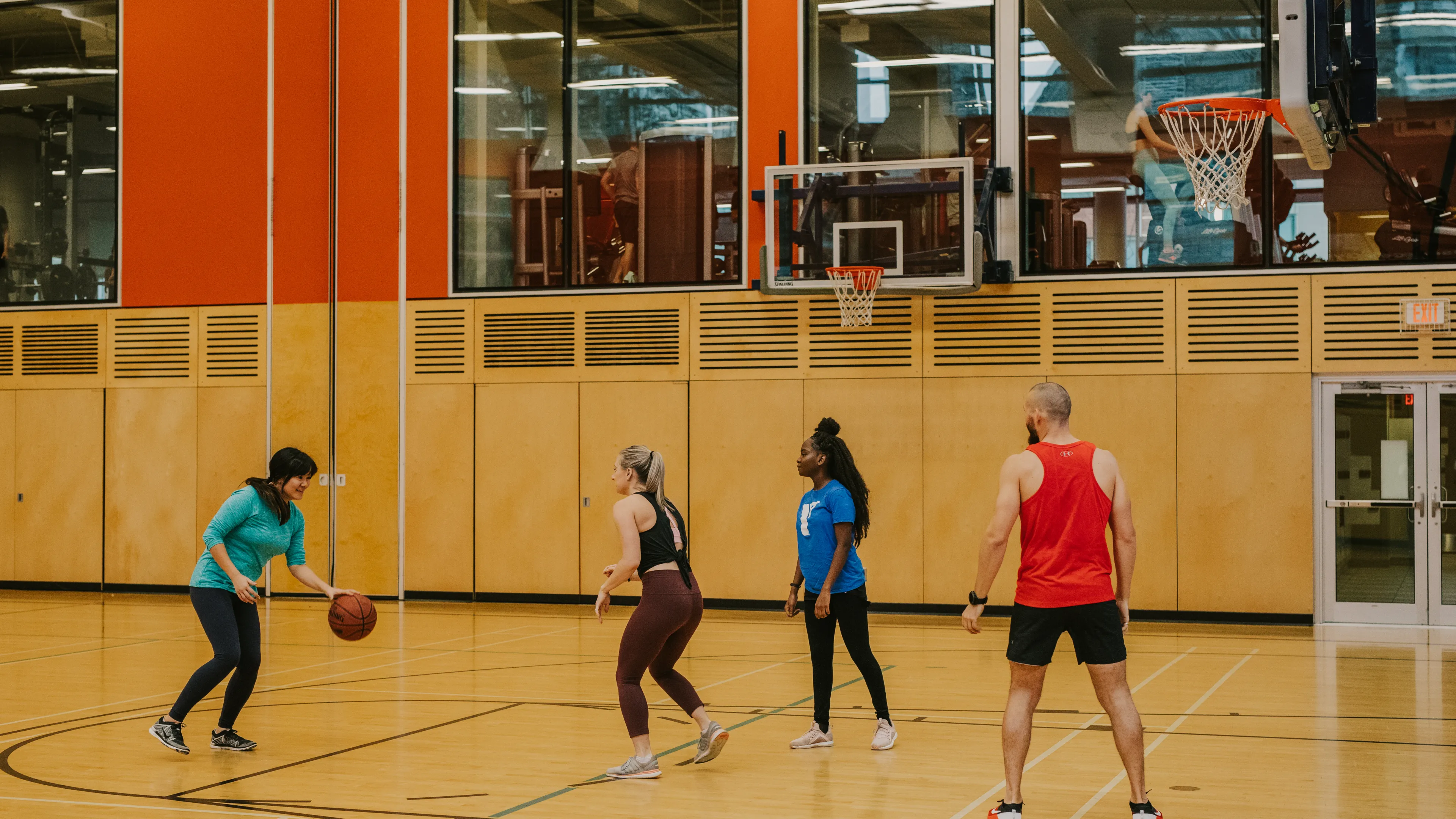 Staff and adults playing basketball