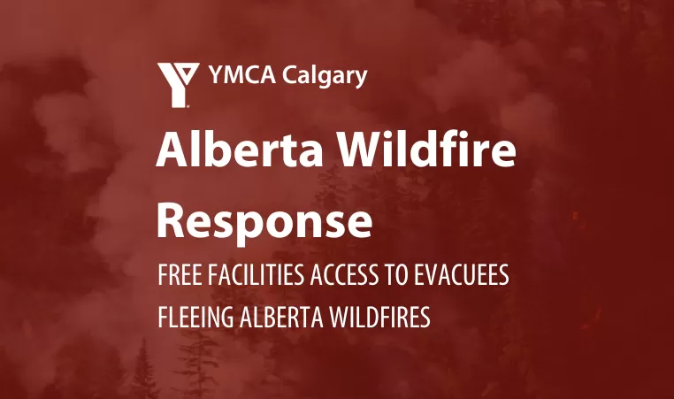 A red sign which reads 'Alberta Wildfire response, free facility access to evacuees fleeing Alberta wildfires.