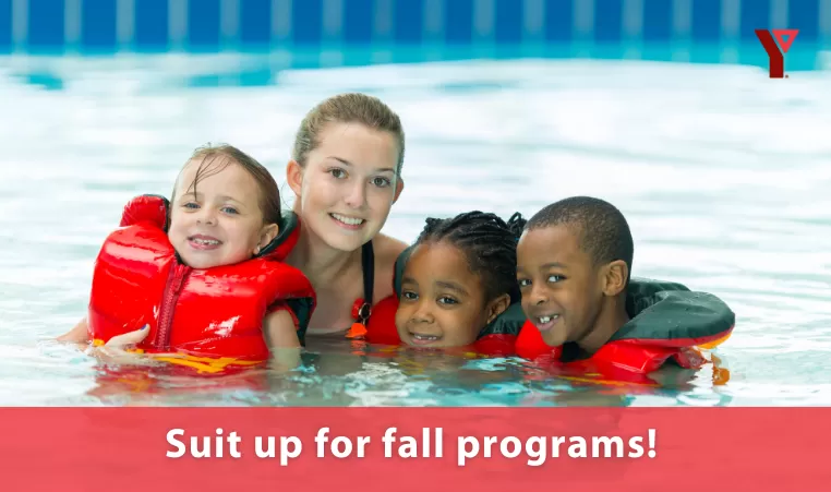 A group of 4 people - 1 adult with 3 kids in lifejackets are in a pool, enjoying life, all smiling at the camera. There is a heading at the bottom of the image that says Suit up for fall programs!