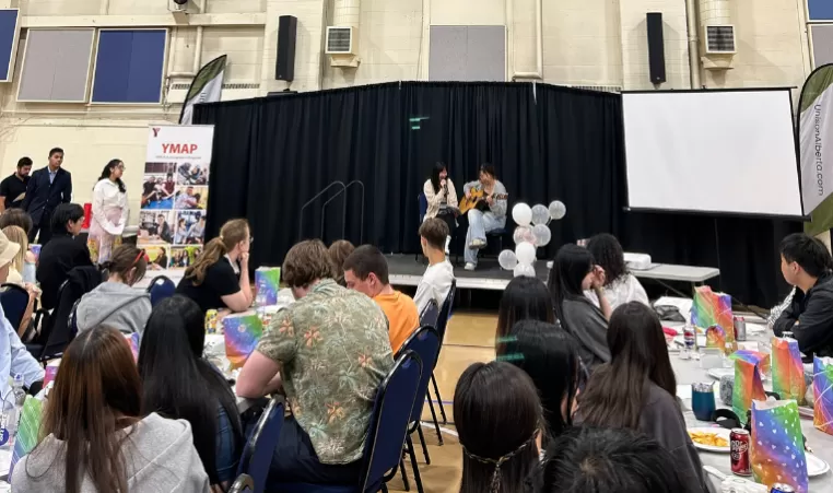 Two YMAP students perform in front of their peers at the YMAP Year-end event.