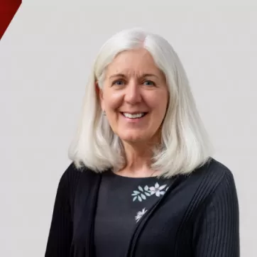 Pat White poses for a headshot on a graphic background