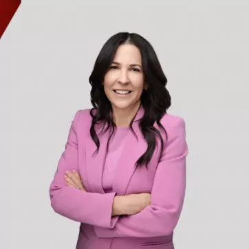 Michele Whelan smiles in front of a graphic background