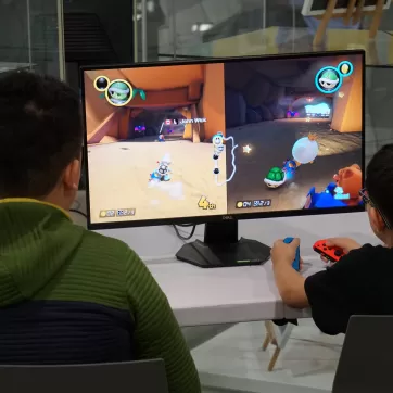 Two kids playing mario kart