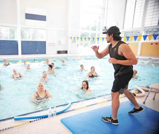fitness instructor teaching people in the pool