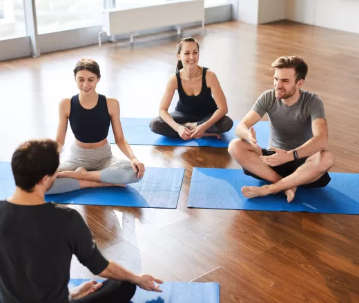 A group gathers on yoga mats in a continuing education course