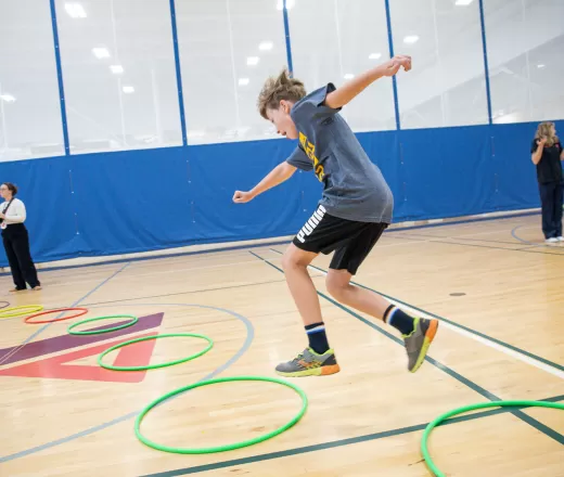 Kid jumping through a hoop