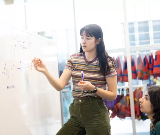 A tutoring volunteer explains an equation at Remington YMCA in Quarry Park