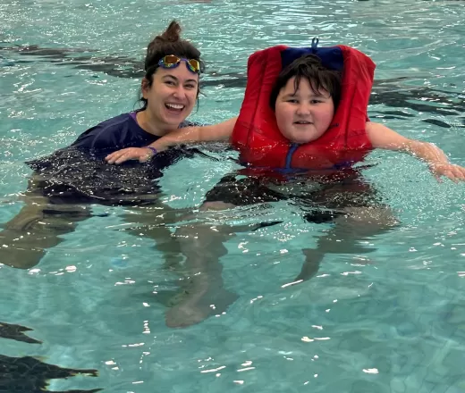 Theo and his teacher, Ms. Cabral swimming at Healthy Living School