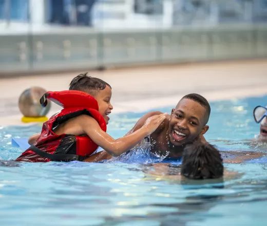 A group of people playing in a pool.