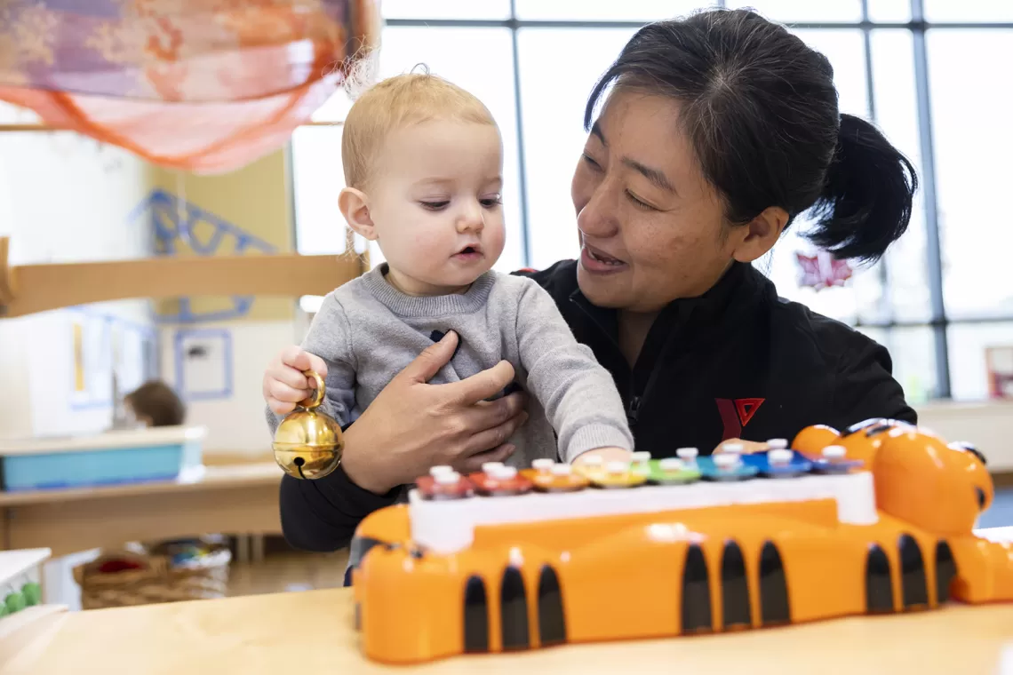 young child hugging educator