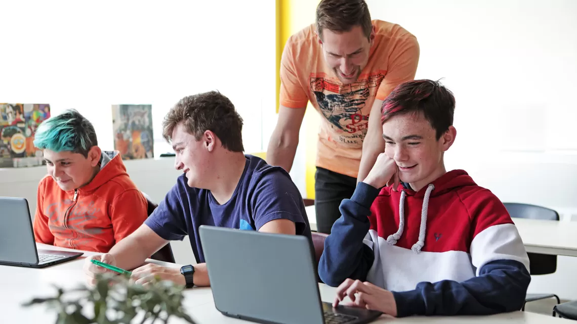 group of youth working on computers