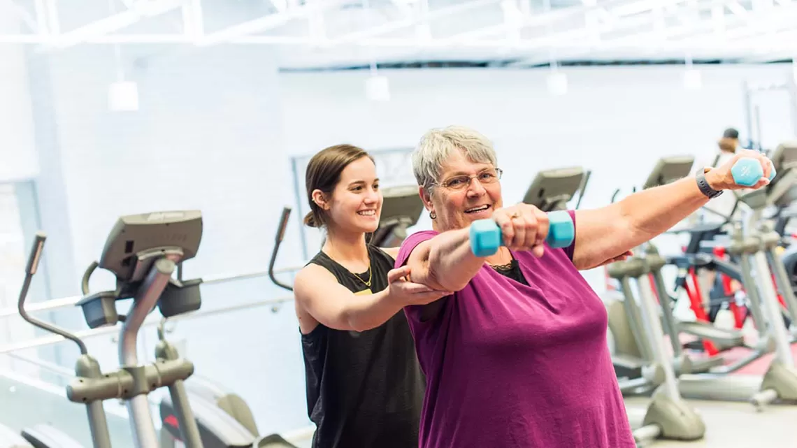 older woman with personal trainer