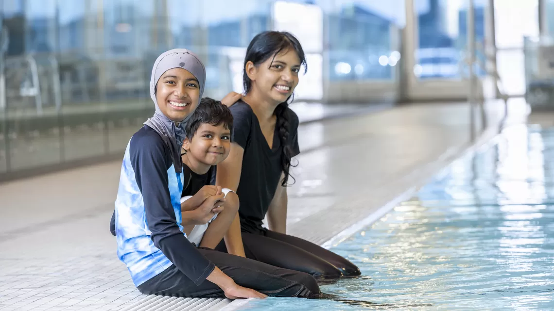 single mom family sitting by the pool