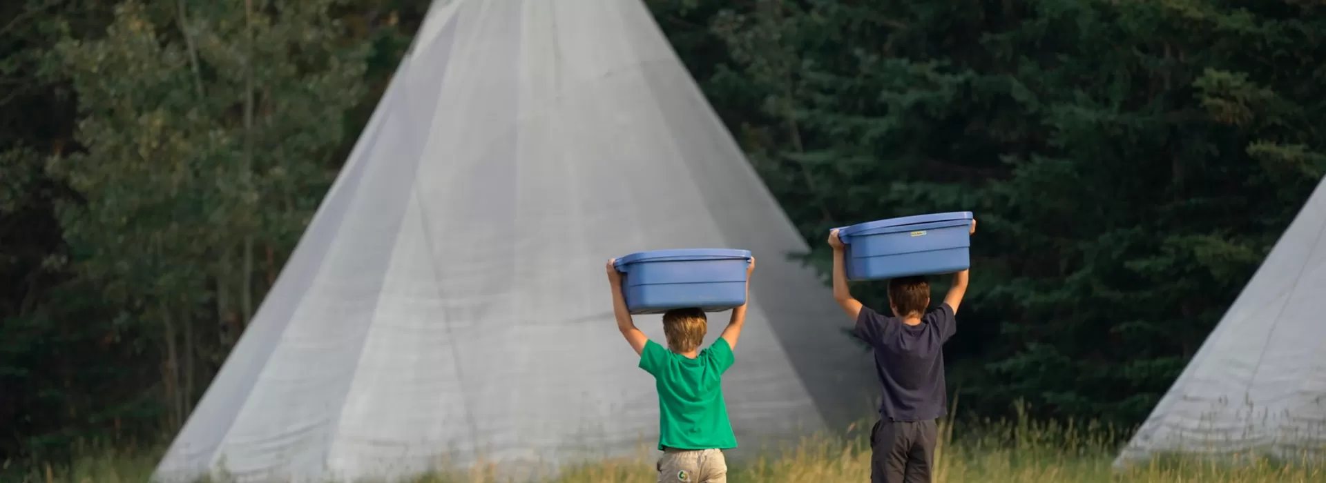 Boys carrying blue buckets to Tipi's